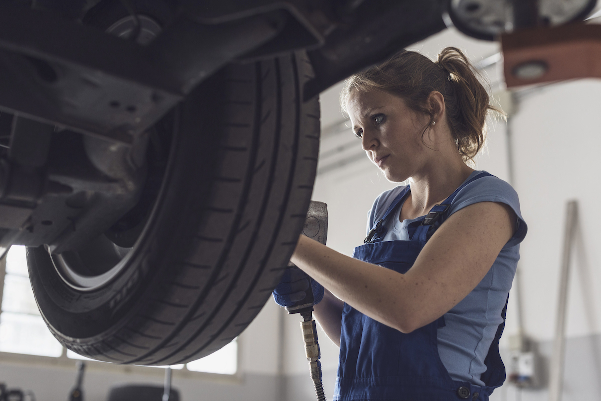 Professional tire technician working on a tire and wheel